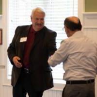 Dean Plotkowski shaking hands with retiree